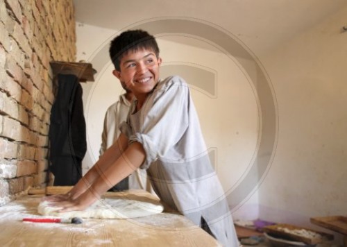 Junge knetet Brotteig in Kunduz