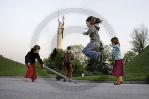 Kinder spielen ein Huepfspiel in Kiew