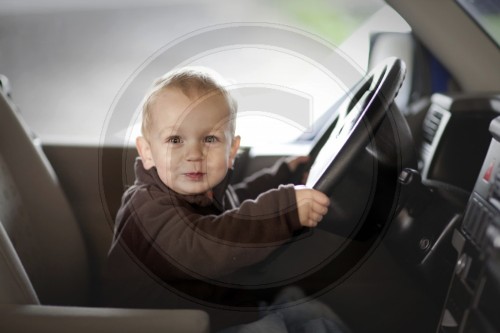 Kleiner Junge sitzt in einem Auto