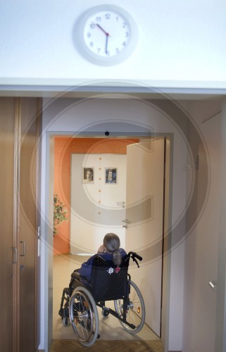 Old woman in a wheelchair in the hallway of a nursing home. Wermelskirchen, Germany. 14.06.2011. MODEL RELEASE available.