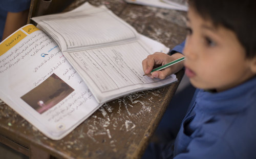 Syrischer Schueler waehrend des Unterrichts an einer Doppelschichtschule in Amman