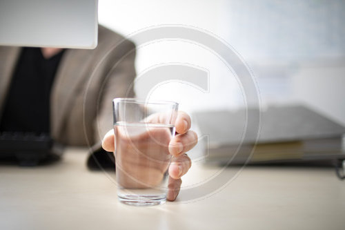 Glas mit Wasser am Arbeitsplatz