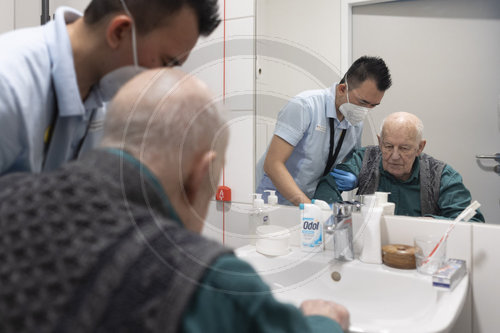 Pflegekraft und alter Mann im Pflegeheim