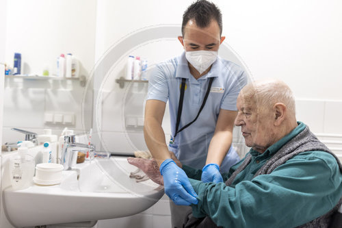 Pflegekraft und alter Mann im Pflegeheim